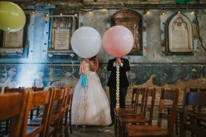 Bride and groom big big balloons covering their faces at the Asylum Chapel London.