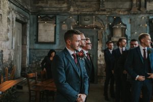 Groom waiting for his bride to walk at the Asylum Chapel in London.