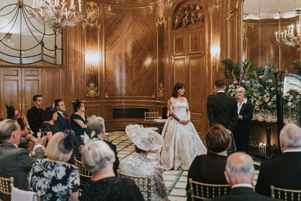 Bride and Groom stand in Art Deco room. 