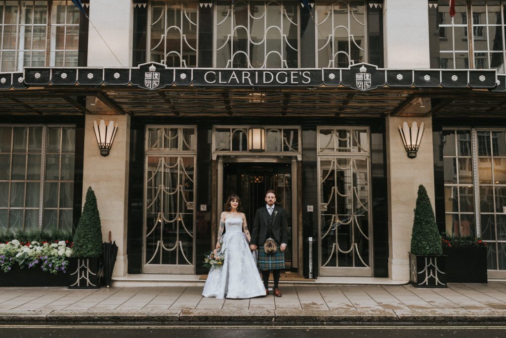 Bride and Groom Stand Outside the Iconic Claridge's in London