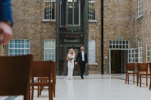 Bride and Groom walking the aisle London Micro Wedding Hackney Town Hall Bride and groom Portraits in arty Shoreditch Alternative Wedding Photographer We Heart Pictures